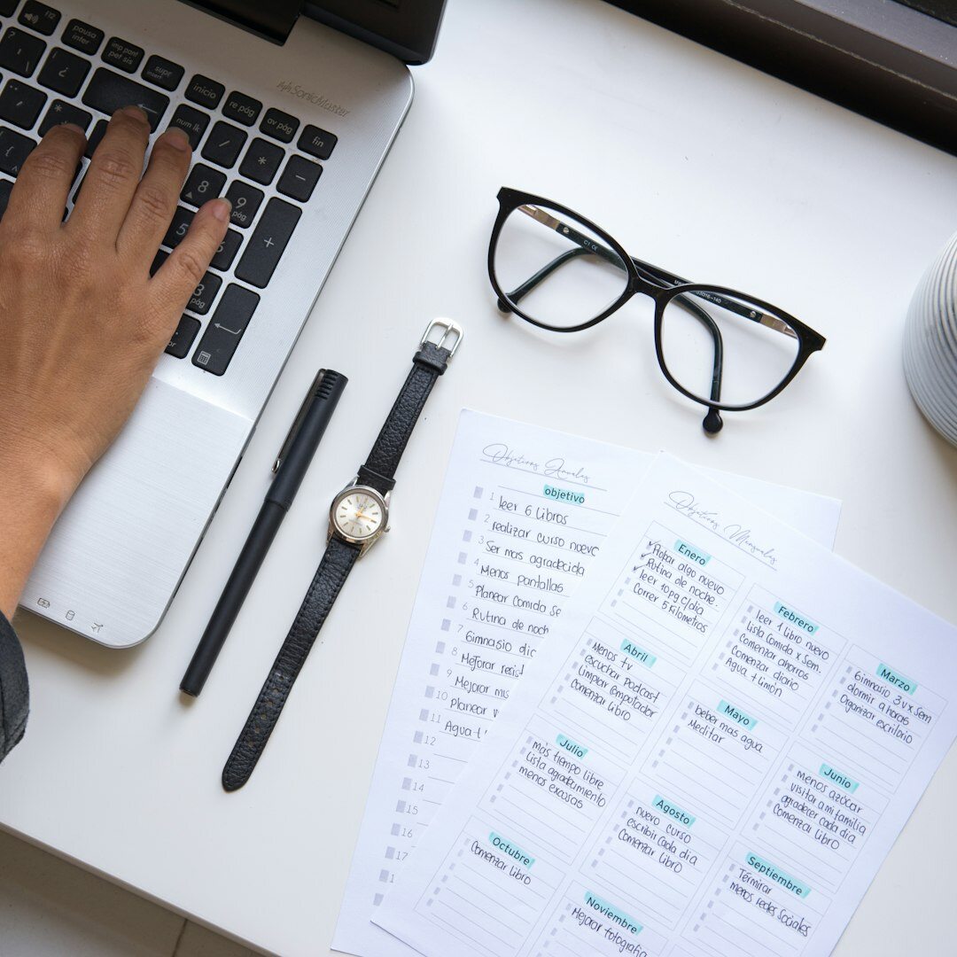 Person writing a script or screenplay in a notebook at a desk